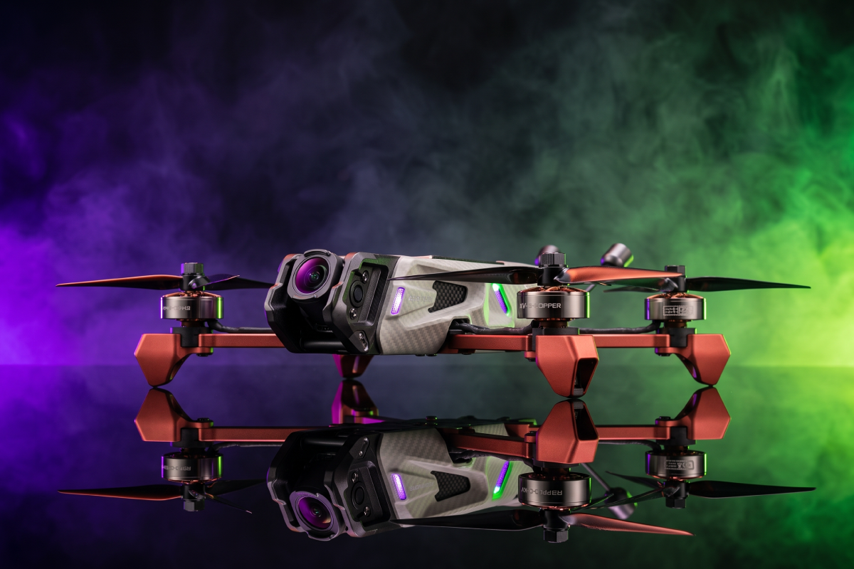 5-inch FPV drone with a digital camera, copper arms and motors, shot in a studio with purple and green smoke